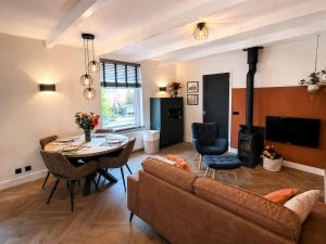 a living room with a couch and a table at Cozy apartment in authentic farmhouse in Gouda