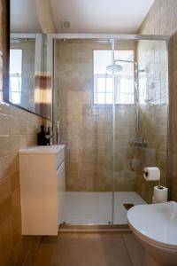 a bathroom with a shower with a toilet and a sink at Sleep in Centre - Old Town in Aveiro