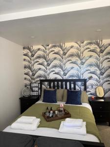 a bedroom with a bed with a wall mural at Rutland Point in Uppingham