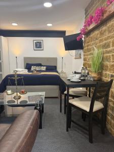 a hotel room with a bed and a table and chairs at Rutland Point in Uppingham