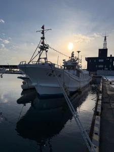 a couple of boats docked in the water at ゲストハウス潮目 in Shibetsu