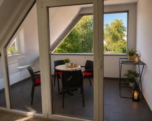 a balcony with sliding glass doors and a table and chairs at Apartmani LU&LO in Delnice