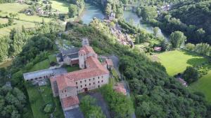 an aerial view of a castle on a hill with a river at Chambres d'Hôtes Le Clos Ambels in Ambialet