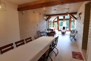 a dining room with a table and chairs in a house at Pensiunea Moldovan in Praid