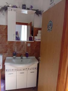 a bathroom with a sink and a mirror at Apartman Lavanda M in Trebinje +15 photos