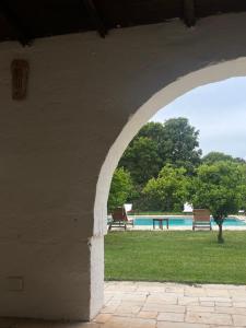 an archway with a view of a swimming pool at Masseria Incantalupi in San Vito dei Normanni