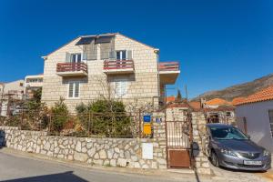 a car parked in front of a house at Apartment Lise in Dubrovnik