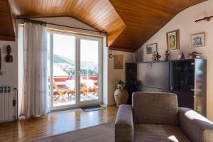 a living room with a couch and a large window at Apartment Lise in Dubrovnik