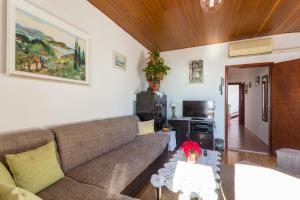 a living room with a couch and a table at Apartment Lise in Dubrovnik