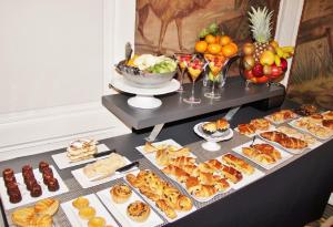 a table topped with appetizers and food on a table at Château Pontet d'Eyrans & Spa in Eyrans-de Soudiac