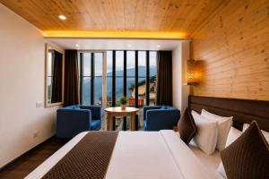 a hotel room with a bed and a table and chairs at Sparrow Elements Boutique 2 min walk To Mg Marg in Gangtok +122 photos