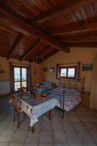 a bedroom with a bed and a table in a room at Strada Casai 19 - Appartamento turistico in villa con giardino e posto auto in Riva Ligure