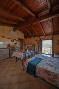 a large room with two beds and a kitchen at Strada Casai 19 - Appartamento turistico in villa con giardino e posto auto in Riva Ligure