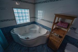 a bath tub in a bathroom with a window at Strada Casai 19 - Appartamento turistico in villa con giardino e posto auto in Riva Ligure +50 photos