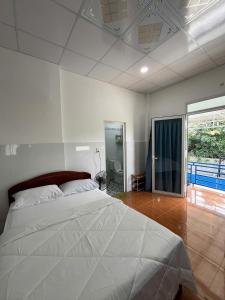 a bedroom with a large white bed in it at VitaSea Mui Ne homestay & pool in Mui Ne