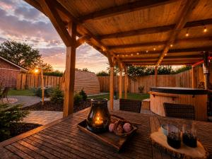 a wooden table with a vase on top of a patio at Landhaus Sweet Escape in Löningen