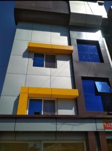 a lego building with blue and yellow windows at Sunset View in Mahabaleshwar