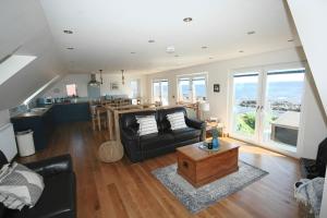 a living room with a couch and a table at The Coopers View in Cellardyke