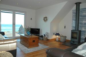 a living room with a couch and a fireplace at The Coopers View in Cellardyke