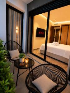 a bedroom with a bed and two chairs and a table at Elegant Studio in Casablanca in Casablanca