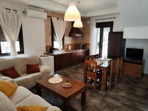 a living room with a couch and a table at Casas Rurales Los Montes in La Corte