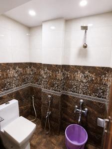 a bathroom with a toilet and a purple bowl at Sunset View in Mahabaleshwar