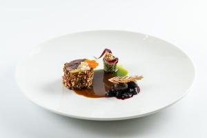 a white plate with a piece of chocolate dessert at Kastély szállás in Nagyréde
