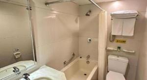 a bathroom with a toilet and a tub and a sink at Macau Masters Hotel in Macau +149 photos