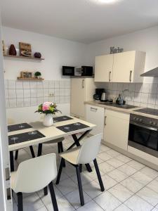 a kitchen with a table and chairs with flowers on it at Elbstone 1 in Wittenberge