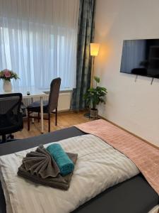 a hotel room with a bed with towels on it at Elbstone 1 in Wittenberge