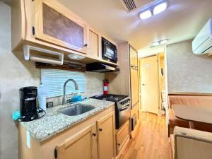 a kitchen with a sink and a stove at Best RV-Camper To Visit NYC-Hot Tub-Free Parking in Hillside +18 photos