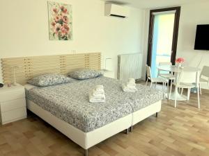 a bedroom with a bed and a table and chairs at Ciconi Garden Studio Apartment in Gorizia