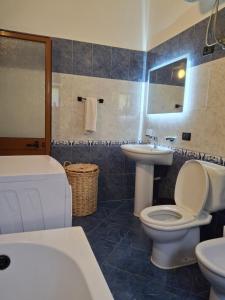 a bathroom with a toilet and a sink at Hills Villa in Vlorë +26 photos