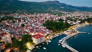 an aerial view of a town with boats in the water at Apartment Coastal Charm in Kaštela