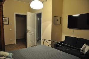 a bedroom with a bed and a flat screen tv at La Tana di Sofia in Rome