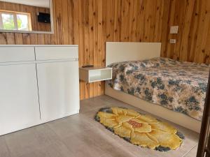 a bedroom with a bed and a dresser and a dresser at Апартаменти Атаман in Zhovtnevoye