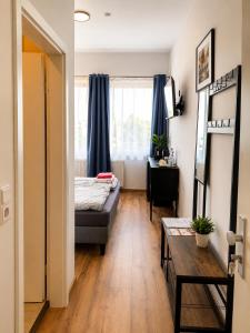 a small room with a bed and a table at LF Sports & Spa Hotel in Hannover