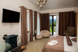 a hotel room with a bed and a tv at Sungora sun&ski resort in Slavske