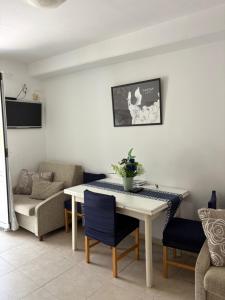 a living room with a table and a couch at Apartments Boras in Cavtat