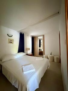 a bedroom with a large white bed in a room at Apartments Boras in Cavtat