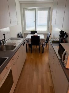 a kitchen with a table and a sink and a table and chairs at Zurich Cozy Room in Zumikon