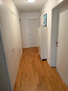 an empty room with white cabinets and a hard wood floor at Zurich Cozy Room in Zumikon