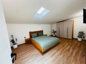 a bedroom with a bed and a skylight at Antonia home 2 in Târgu-Mureş