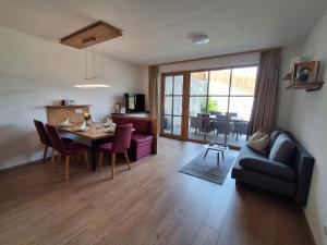 a living room with a dining table and a couch at Landhaus Eiter in Arzl im Pitztal