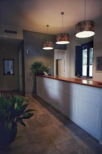a bar in a room with two potted plants at Hotel del Balneario in Tolox +43 photos