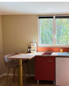 a kitchen with a table and two windows at A Casa Rosa in Omessa +6 photos