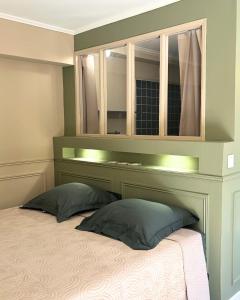 a bedroom with a bed with a mirror above it at A Casa Rosa in Omessa