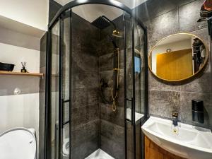 a bathroom with a shower and a sink and a mirror at IN Apartments in Prešov +106 photos