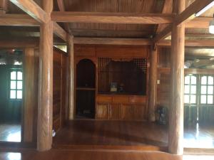 an empty room with wooden walls and wooden floors at Trà My Homestay in Nhữ Khê