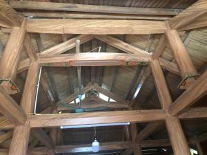 a ceiling of a wooden building with a chandelier at Trà My Homestay in Nhữ Khê +3 photos